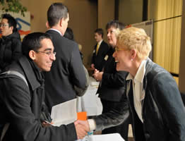 Karen McLaughlin shaking hands with a student